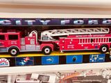 a toy fire truck and a toy firetruck in a display case