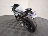 a motorcycle that is parked in a room with a checkered floor