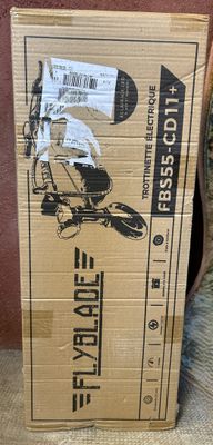 une boîte sur laquelle est représentée une moto posée sur un canapé