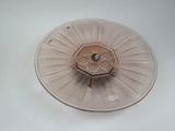 a glass plate with a flower on it on a white surface