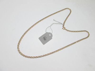 a close up of a gold chain with a tag on it