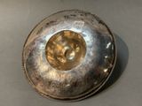 a silver bowl on a table with a silver lid