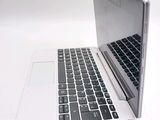 a laptop computer sitting on top of a white table