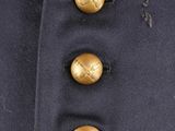 a close up of a coat with gold buttons on it