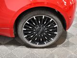 a close up of a red car with black rims