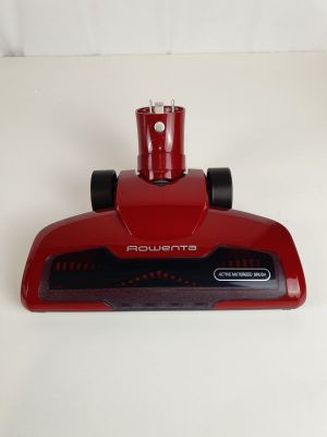 a close up of a red vacuum cleaner on a white surface