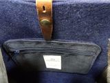 a close up of a purse with a leather strap