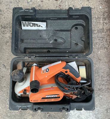 an orange and black box with tools in it sitting on the ground