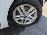 a close up of a tire on a white car