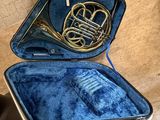 a blue case with a brass instrument inside of it