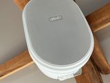 a speaker that is attached to the ceiling in the room