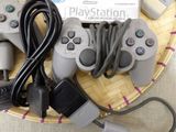 a basket with two controllers and a charger on it