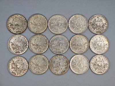 a close up of a bunch of silver coins on a table