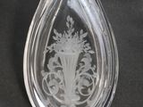 an image of a glass bottle with a design on it