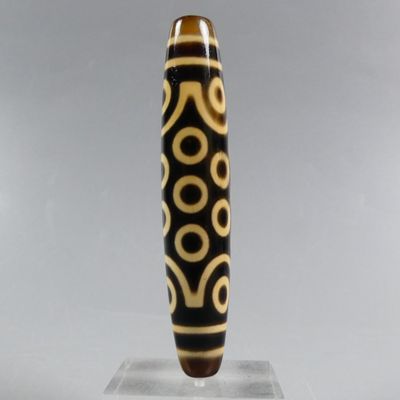 a close up of a black and white pen on a clear base