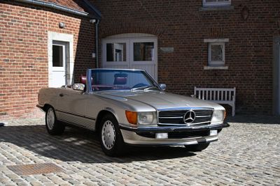 a silver car parked in front of a brick building