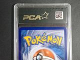 the pokemon card is in a plastic case on a table