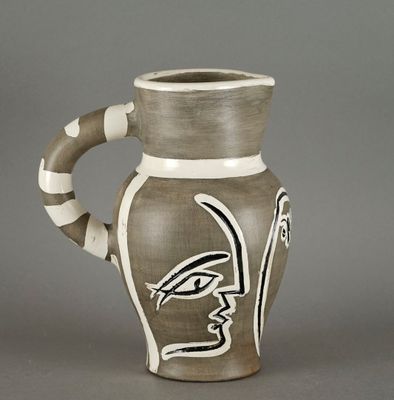 a brown and white vase with a bird painted on it
