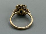 an image of a gold ring with a black diamond