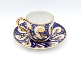 a blue and white cup and saucer on a saucer