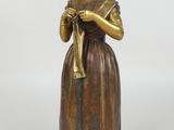 an image of a statue of a woman with a hat and a cane