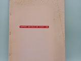 an old book with a red sticker on it sitting on a blue surface