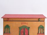 an image of a wooden box with a red roof and a red door