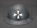 a helmet with a cross on it sitting on a table