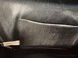 a close up of a black bag with a label on it