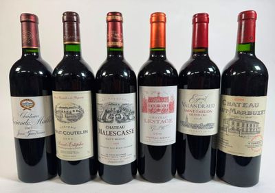 six bottles of wine are lined up in a row on a white surface