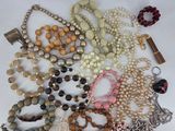 a lot of beads and necklaces on a table
