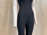 the mannequin is wearing a black jumpsuit and a white top