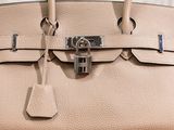 an image of a close up of a purse with a padlock on it