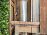a metal pipe that is inside of a wooden box