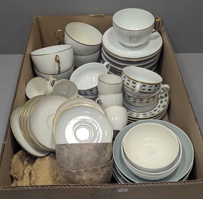 a box full of dishes and cups and saucers