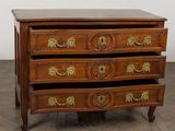 an image of a wooden chest of drawers with brass handles