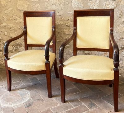 two chairs sitting next to each other on a brick floor