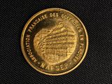 an image of a gold coin with a picture of a building