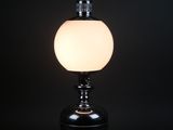 a black table lamp with a white glass ball on top
