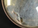 a reflection of a person in a mirror on a black surface