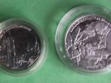two quarters of the united states are shown on a green surface
