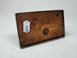 a small wooden box with a label on it