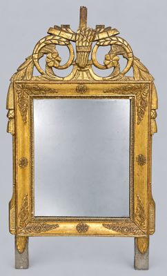 mirror with a gold frame and a decorative design on the front