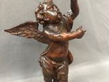 a bronze statue of an angel holding a dove