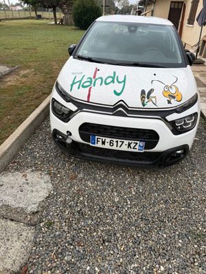 a small white car with a sticker on the front