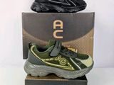 a pair of black and green sneakers on top of a box