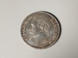 a silver coin with a woman ' s face on it