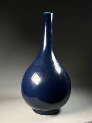 a blue vase that is sitting on a table