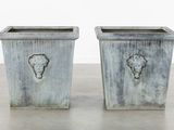 two planters that are sitting on a table