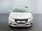 the front view of a white car in a room with a black floor